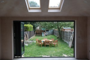 Open bi-folding doors linking the garden to the house