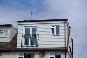 Loft conversion with dormer cladded with weather board
